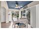 Bright dining area with a ceiling fan, white furniture, and views of the outdoors through sliding glass doors at 815 Montrose Dr # 103, Venice, FL 34293