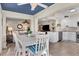 Open-concept dining area showcasing a white table set, living room and modern kitchen at 815 Montrose Dr # 103, Venice, FL 34293
