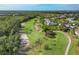 Beautiful golf course view with lush greenery, sand traps, and palm trees at 815 Montrose Dr # 103, Venice, FL 34293