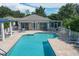 Community pool area with adjacent clubhouse and seating at 815 Montrose Dr # 103, Venice, FL 34293