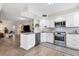 Modern kitchen featuring white cabinets, stainless steel appliances, and granite countertops at 815 Montrose Dr # 103, Venice, FL 34293