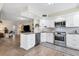 Updated kitchen featuring white cabinets and granite countertops at 815 Montrose Dr # 103, Venice, FL 34293