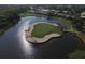 Aerial view of a golf course island green surrounded by water at 815 Montrose Dr # 103, Venice, FL 34293