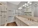 Elegant bathroom with double vanity, quartz countertops and a walk-in shower at 830 The Esplanade N # 203, Venice, FL 34285