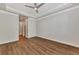 Spacious bedroom with wood-look floors and access to hallway at 830 The Esplanade N # 203, Venice, FL 34285