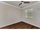 Simple bedroom with wood-look floors and window shutters at 830 The Esplanade N # 203, Venice, FL 34285