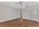 Bright bedroom with wood-look floors and ceiling fan at 830 The Esplanade N # 203, Venice, FL 34285