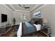 Main bedroom with hardwood floors, window shutters, and staged furniture at 830 The Esplanade N # 203, Venice, FL 34285