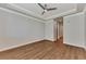 Bright bedroom with wood-look floors, ceiling fan and access to bathroom at 830 The Esplanade N # 203, Venice, FL 34285