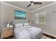 Bedroom with wood floors, large window, and staged furniture at 830 The Esplanade N # 203, Venice, FL 34285
