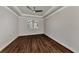 Well-lit bedroom with wood-look floors and window shutters at 830 The Esplanade N # 203, Venice, FL 34285