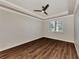 Bright bedroom with wood-look floors, ceiling fan, and large windows at 830 The Esplanade N # 203, Venice, FL 34285