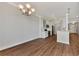 Elegant dining room with hardwood floors and chandelier at 830 The Esplanade N # 203, Venice, FL 34285