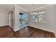 Bright dining room with hardwood floors and sliding glass doors leading to a balcony with ocean views at 830 The Esplanade N # 203, Venice, FL 34285