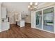 Bright dining room with hardwood floors, balcony access and chandelier at 830 The Esplanade N # 203, Venice, FL 34285