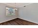 Bright dining room with hardwood floors and large window at 830 The Esplanade N # 203, Venice, FL 34285