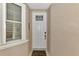 Private condo entrance with a modern door at 830 The Esplanade N # 203, Venice, FL 34285