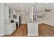 Modern kitchen with white cabinets and island at 830 The Esplanade N # 203, Venice, FL 34285