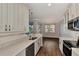 Modern kitchen with stainless steel appliances and white cabinets at 830 The Esplanade N # 203, Venice, FL 34285
