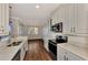 Modern kitchen with stainless steel appliances and white cabinets at 830 The Esplanade N # 203, Venice, FL 34285