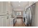 Modern kitchen with stainless steel appliances and white cabinets at 830 The Esplanade N # 203, Venice, FL 34285