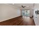 Spacious living room featuring hardwood floors and sliding glass doors to a balcony at 830 The Esplanade N # 203, Venice, FL 34285