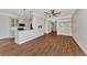 Open living room and kitchen with wood flooring at 830 The Esplanade N # 203, Venice, FL 34285