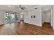 Open living room with hardwood floors and access to a balcony and kitchen at 830 The Esplanade N # 203, Venice, FL 34285