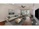 Living room with hardwood floors, staged furniture, and access to a balcony at 830 The Esplanade N # 203, Venice, FL 34285