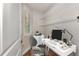 Home office with wire shelving and built-in desk at 830 The Esplanade N # 203, Venice, FL 34285