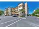 Building exterior with parking and landscaping at 830 The Esplanade N # 203, Venice, FL 34285