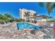 Inviting community pool with lounge chairs and a shaded seating area at 830 The Esplanade N # 203, Venice, FL 34285