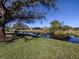 Scenic view of a canal with lush landscaping and houses in the background at 885 Country Club Cir # 61, Venice, FL 34293