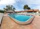 Relaxing community pool with patio furniture and shaded areas at 885 Country Club Cir # 61, Venice, FL 34293