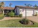 Exterior view of a house with a terracotta tile roof and landscaping at 885 Country Club Cir # 61, Venice, FL 34293