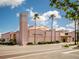 Exterior view of the Venice Theatre, a pink building with palm trees at 885 Country Club Cir # 61, Venice, FL 34293