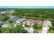 Aerial view of neighborhood homes surrounded by lush greenery at 9920 Sheltering Spruce St, Englewood, FL 34223