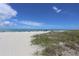 Expansive beach view with ocean and blue sky at 9920 Sheltering Spruce St, Englewood, FL 34223