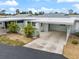 Home with carport and tropical landscaping at 1018 Beach Manor Cir # 40, Venice, FL 34285