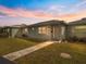 Light teal single story home with walkway and landscaped lawn at 1018 Beach Manor Cir # 40, Venice, FL 34285