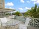 Relaxing patio area with glass-top table and chairs at 1018 Beach Manor Cir # 40, Venice, FL 34285