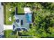 Aerial view of house with solar panels, pool, and lush landscaping at 1030 Phorus Rd Rd, Venice, FL 34293