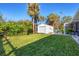 Large backyard with shed and lush landscaping at 1030 Phorus Rd Rd, Venice, FL 34293