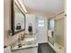 Updated bathroom with granite countertop, walk-in shower, and modern vanity at 1030 Phorus Rd Rd, Venice, FL 34293