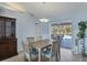 Dining room with light wood table and chairs, view of pool at 1030 Phorus Rd Rd, Venice, FL 34293