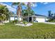 House exterior with a charming, coastal-inspired design and solar panels at 1030 Phorus Rd Rd, Venice, FL 34293