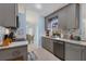 Modern kitchen featuring gray cabinets and granite countertops at 1030 Phorus Rd Rd, Venice, FL 34293