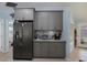 Modern kitchen with gray cabinets, granite countertops, and stainless steel appliances at 1030 Phorus Rd Rd, Venice, FL 34293