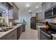 Modern kitchen with gray cabinets, granite counters, and stainless steel appliances at 1030 Phorus Rd Rd, Venice, FL 34293