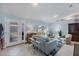 Living room with gray couches and large windows, view of entryway at 1030 Phorus Rd Rd, Venice, FL 34293